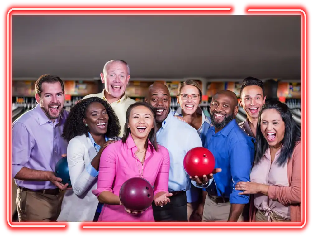 Large group of coworkers posing with bowling balls at Victory Lanes in Decatur, IL as part of team building event