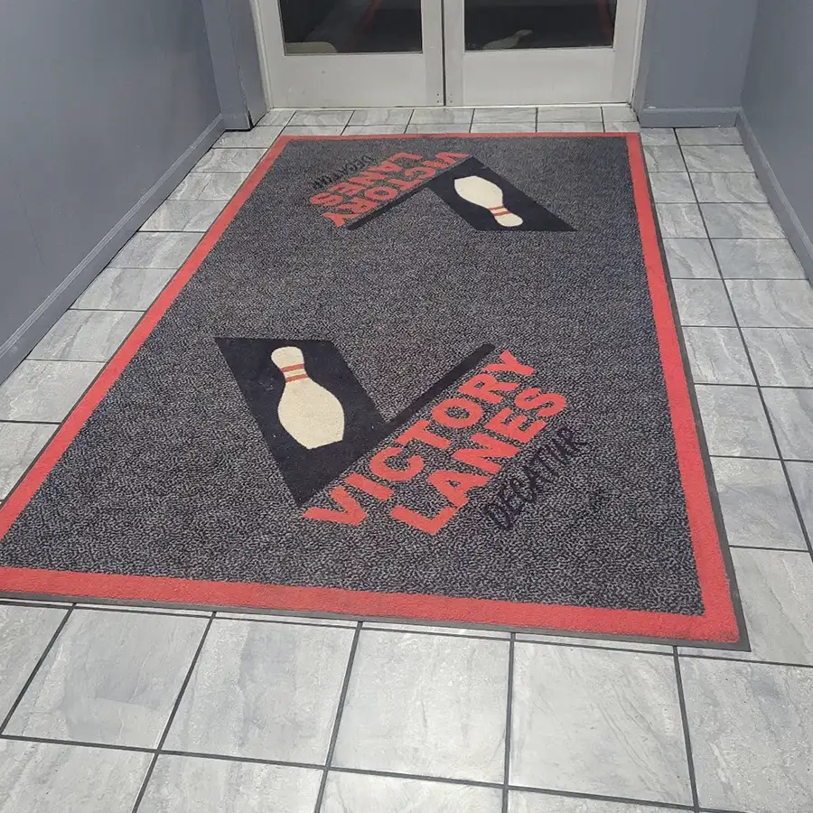 Victory Lanes logo welcome mat at the entrance of the bowling center in Decatur, IL